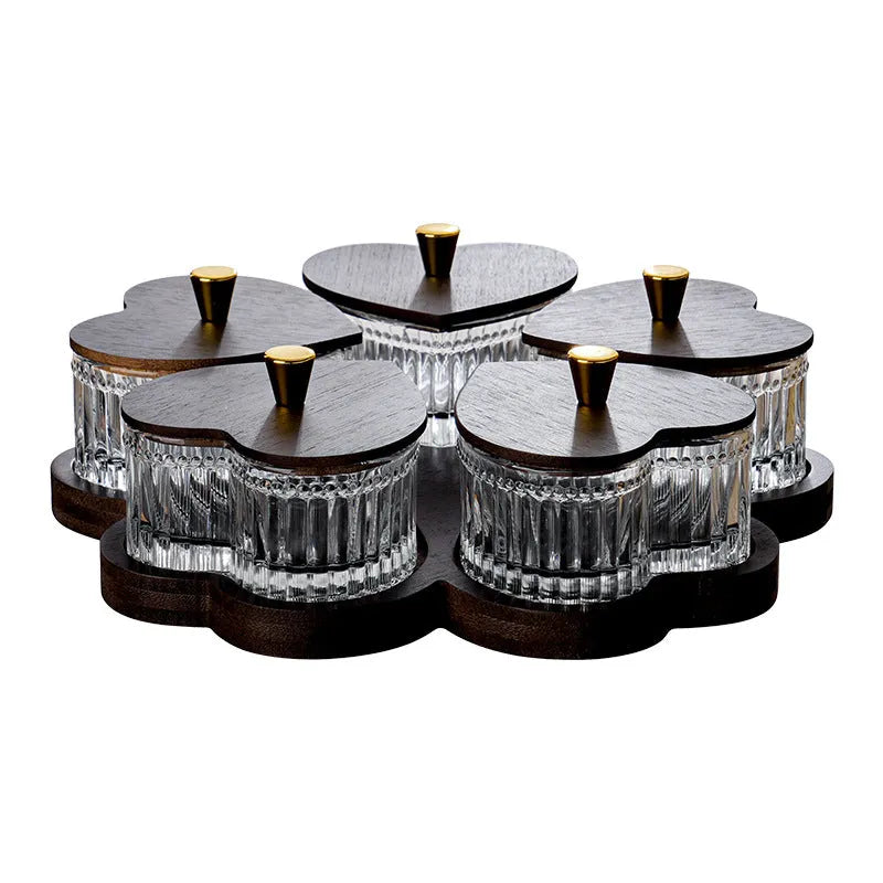 Glass foot bath fruit platter with coloured glaze and transparent heart-shaped lids on a multi-grid snack tray.