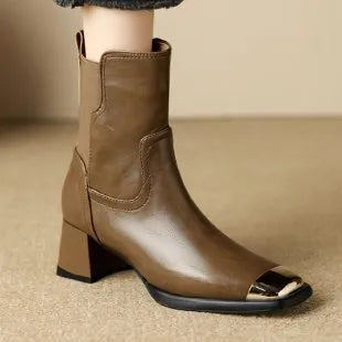 Brown women's Martin boots with high heel and side zip on a white background.