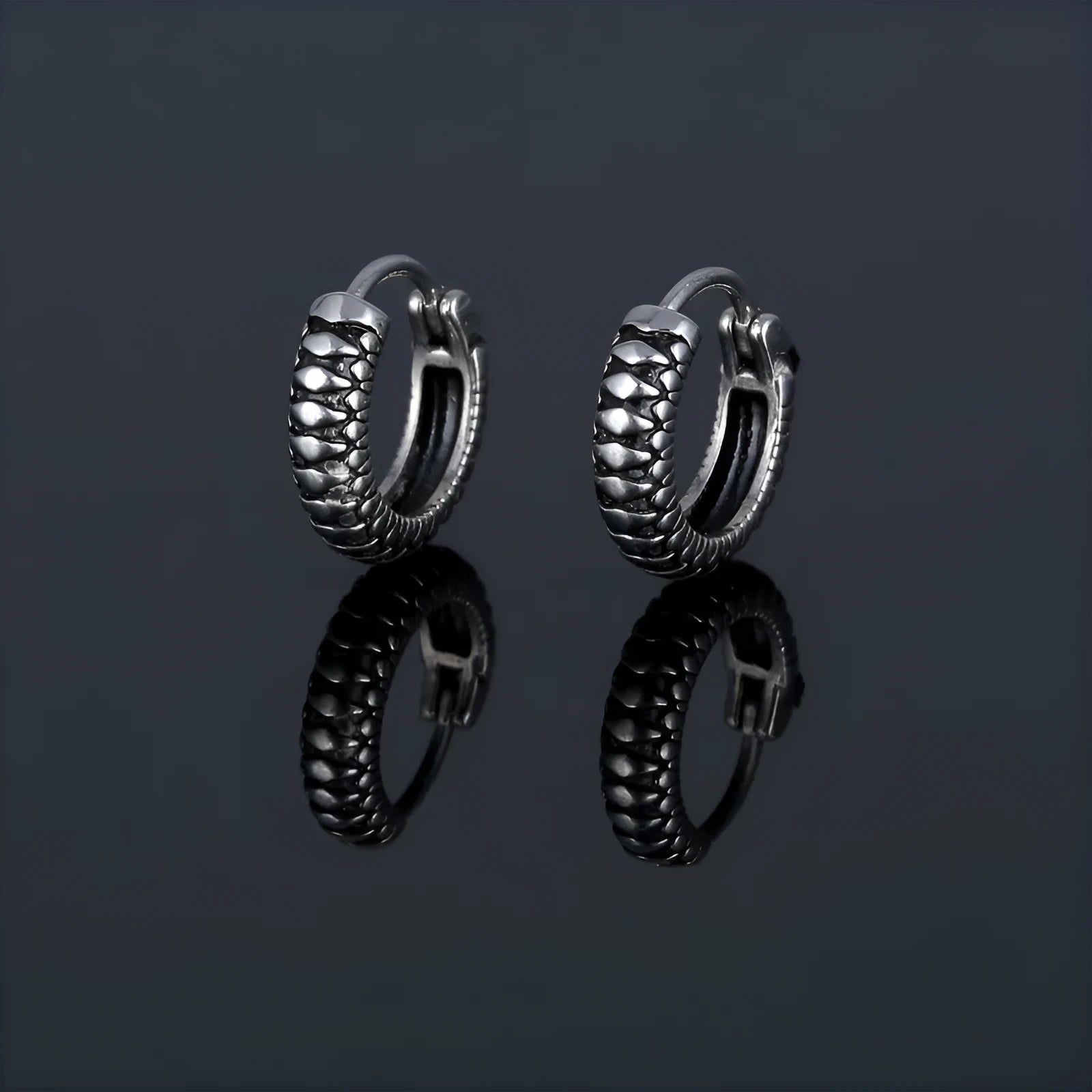 Silver titanium steel geometric twist earrings with round sports-style elements