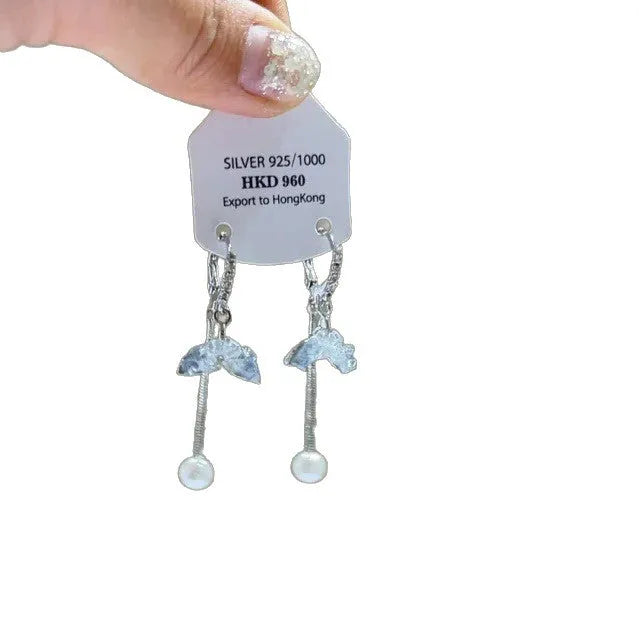 Close-up of women's geometric alloy earrings with rhinestones, a dangling tassel, and a heart detail.