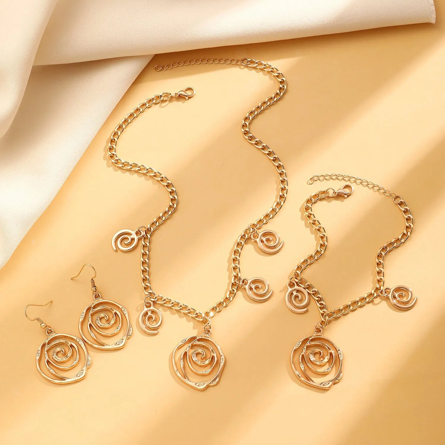 Spiral donut geometric jewellery set with necklace bracelet earrings in gold finish