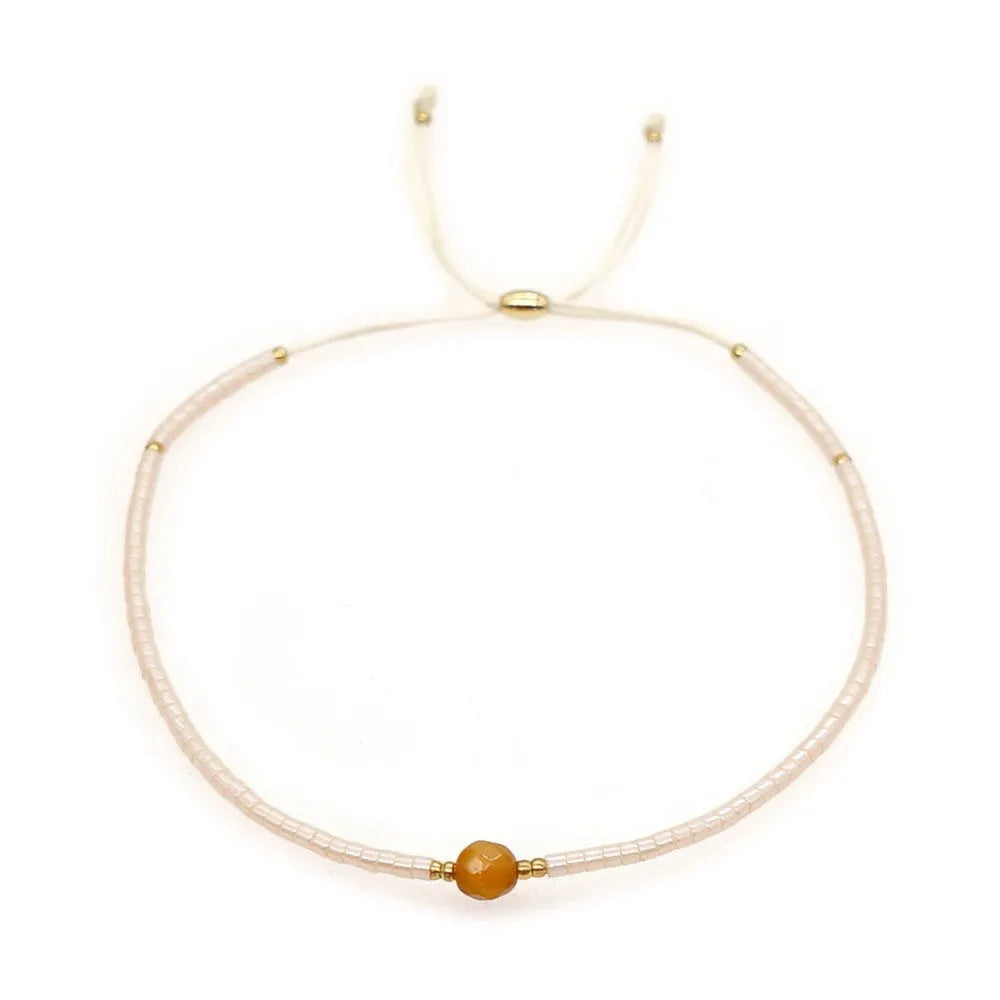 Bohemian style women's bracelet with semi-precious stone and colourful glass beads on adjustable fastening