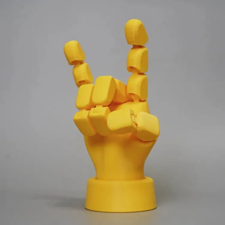 Yellow movable joint hand ornament figurine on a plain background.