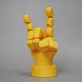 Yellow movable joint hand ornament figurine on a plain background.