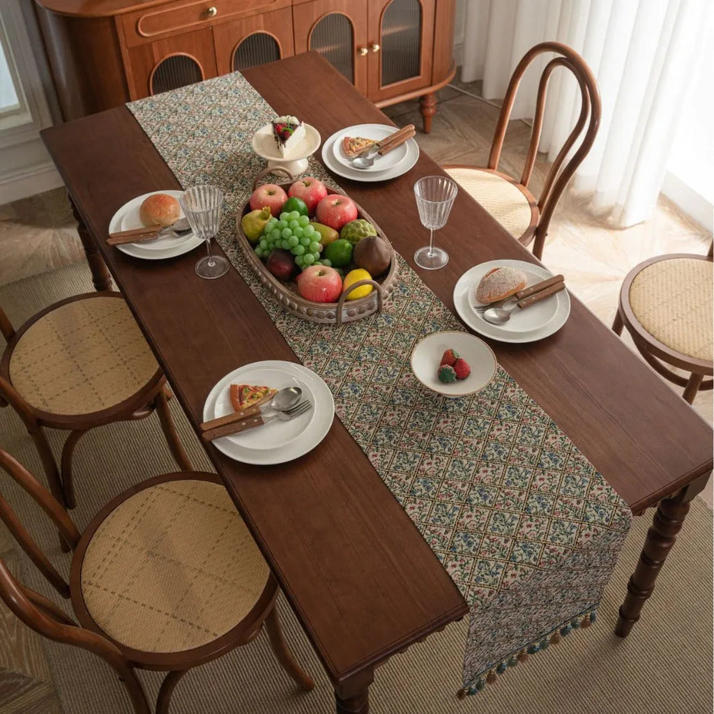 Nordic jacquard bouquet pattern table runner with tassels in dark blue on wooden table