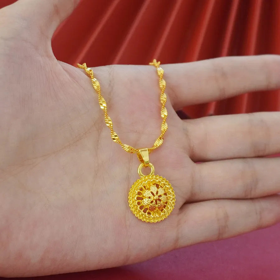 Three-piece gold-plated jewellery set with floral design including pendant necklace, earrings and ring