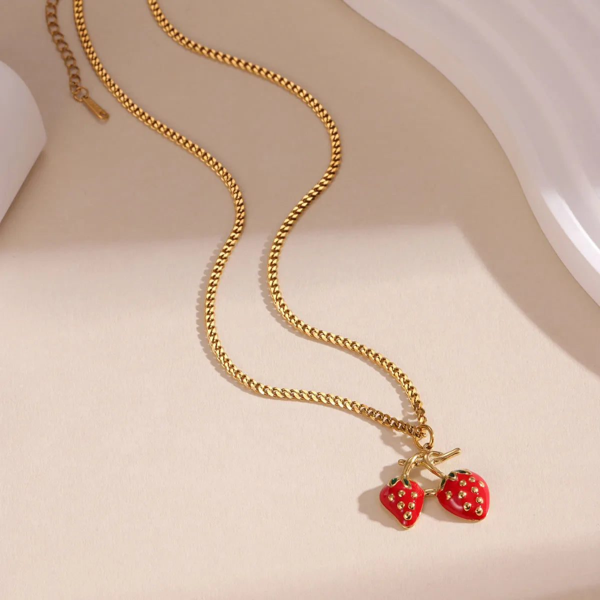 Stainless steel necklace with a detailed strawberry fruit pendant in red or white gradient finish.