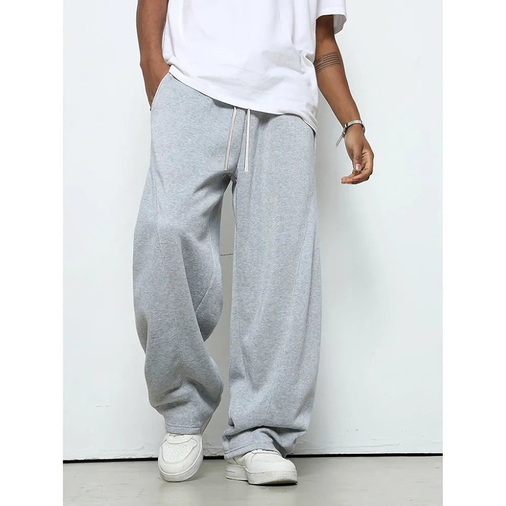 Man wearing solid grey straight-leg casual trousers with an elasticated waistband.