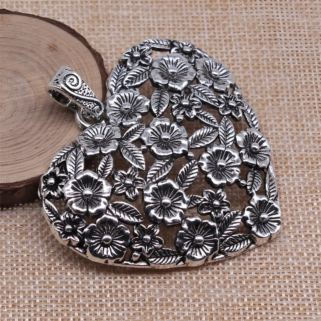 Hollow flower love pendant in ancient silver alloy measuring 67x58mm
