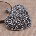 Hollow flower love pendant in ancient silver alloy measuring 67x58mm