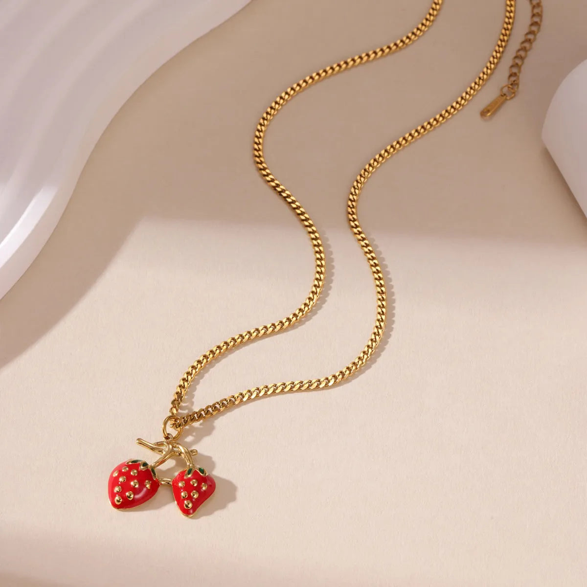 Stainless steel necklace with a detailed strawberry fruit pendant in red or white gradient finish.
