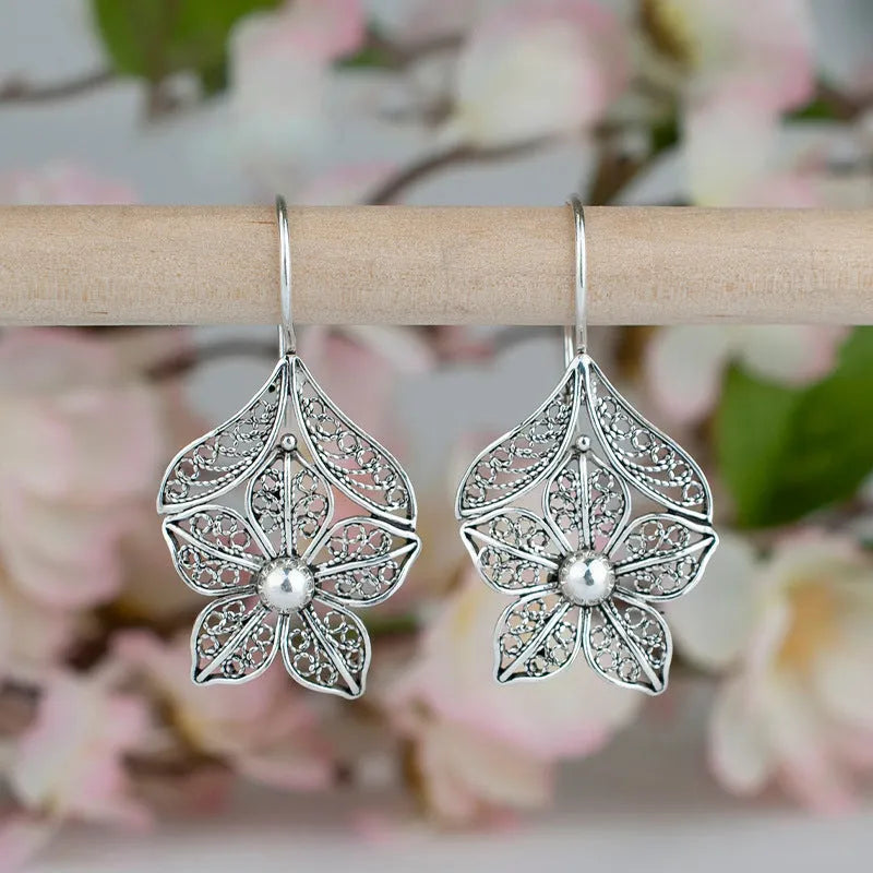 Silver alloy hollow flower and leaf-shaped earrings for women, retro simple design