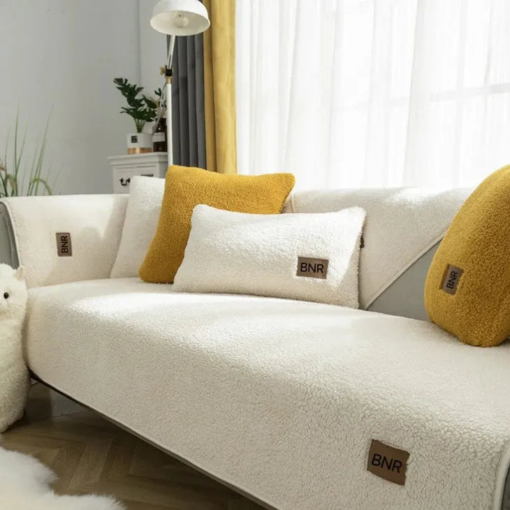 Lambswool solid colour sofa cover in blue on a sofa, showing simple slipcover style.
