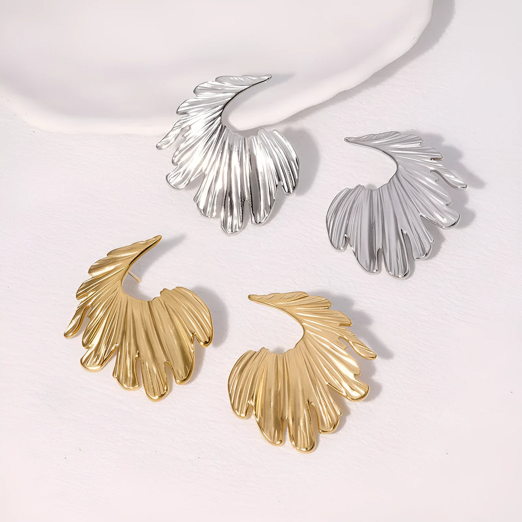 Pair of gold electroplated stainless steel leaf-shaped stud earrings on a white background