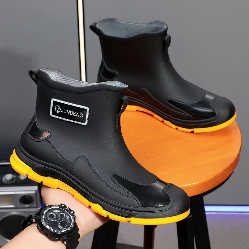 Solid colour low tube PVC rain boots with flat heel and round toe, integrated moulding sole, available in black, black and yellow, khaki