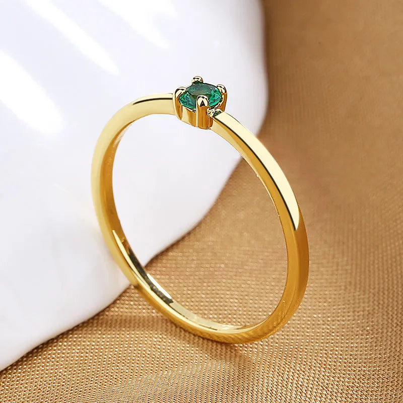 Copper fine circle ring for women with a single diamond, shown in blue, green, red, and white colour options.