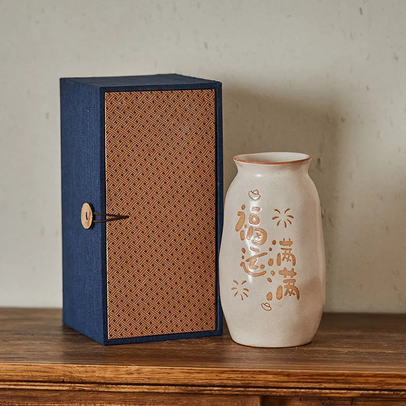 Chinese hand-painted ceramic joy vase with symbolic motifs on wooden desk