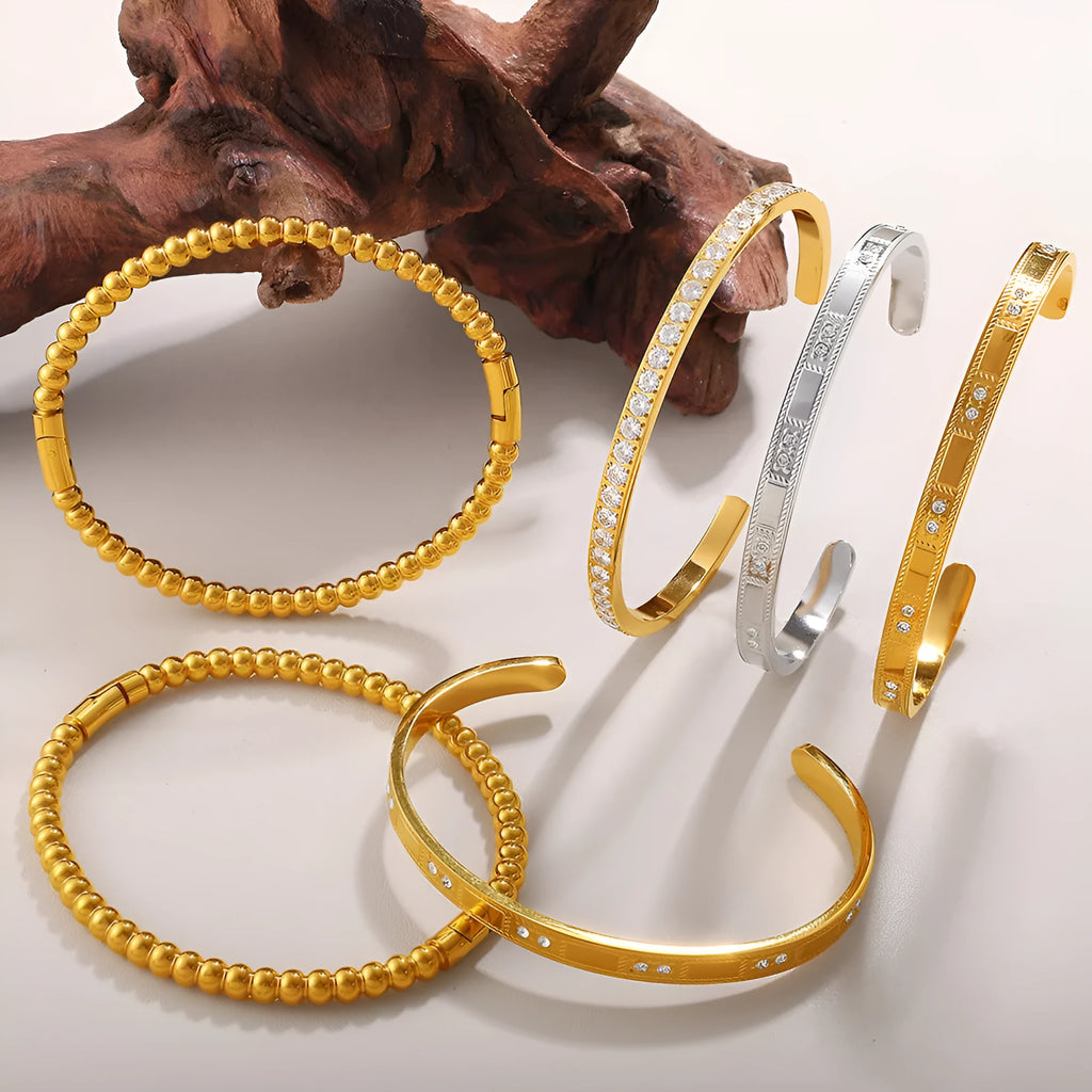 Stainless steel open-end buckle bracelet with electroplated finish, available in gold, white zirconium, and white diamond colours