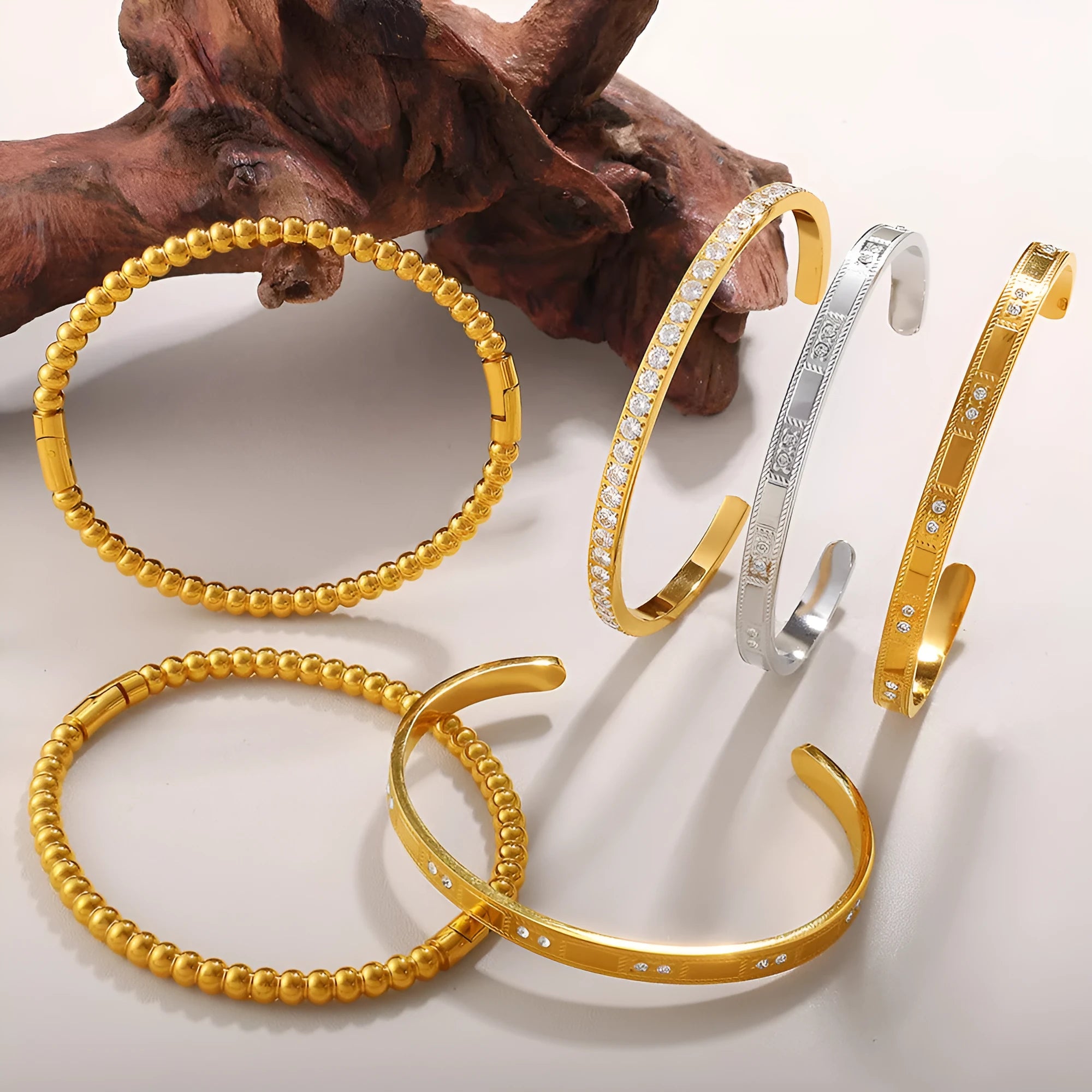 Stainless steel open-end buckle bracelet with electroplated finish, available in gold, white zirconium, and white diamond colours