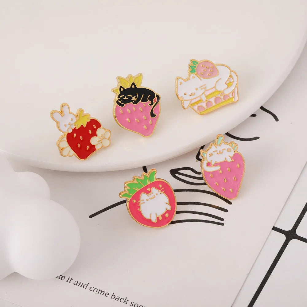Cat strawberry metal brooch with alloy finish in five colour options on a bag