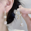 Silver drop earrings with a tassel and rhinestone ball pendant on copper findings.