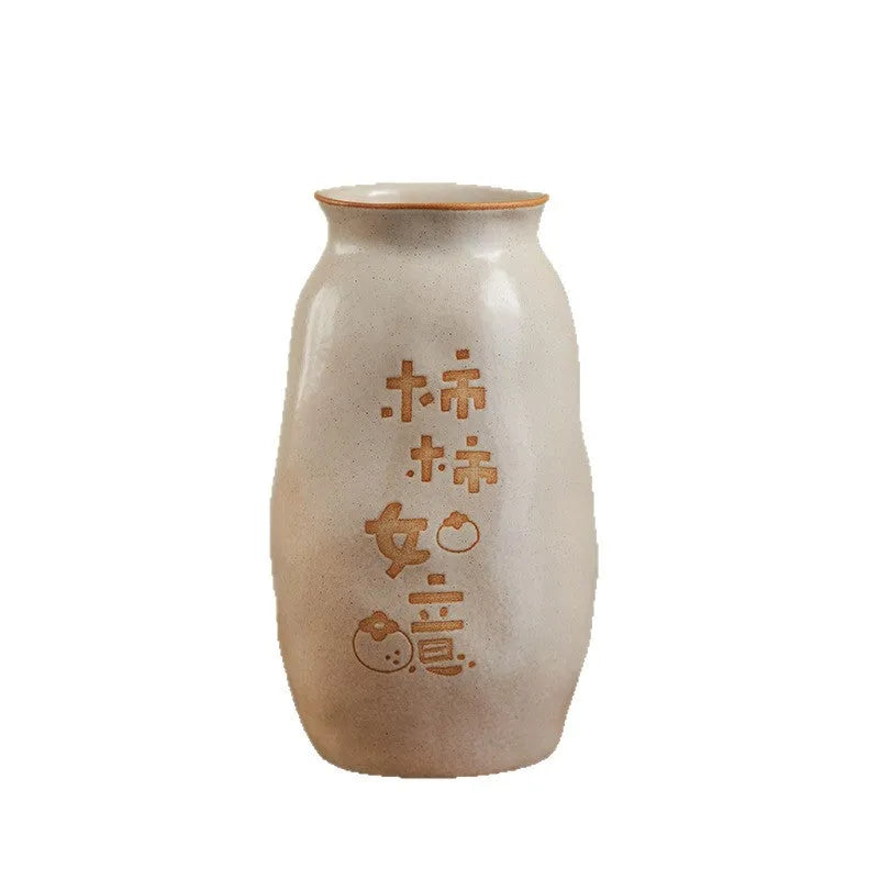 Chinese hand-painted ceramic joy vase with symbolic motifs on wooden desk