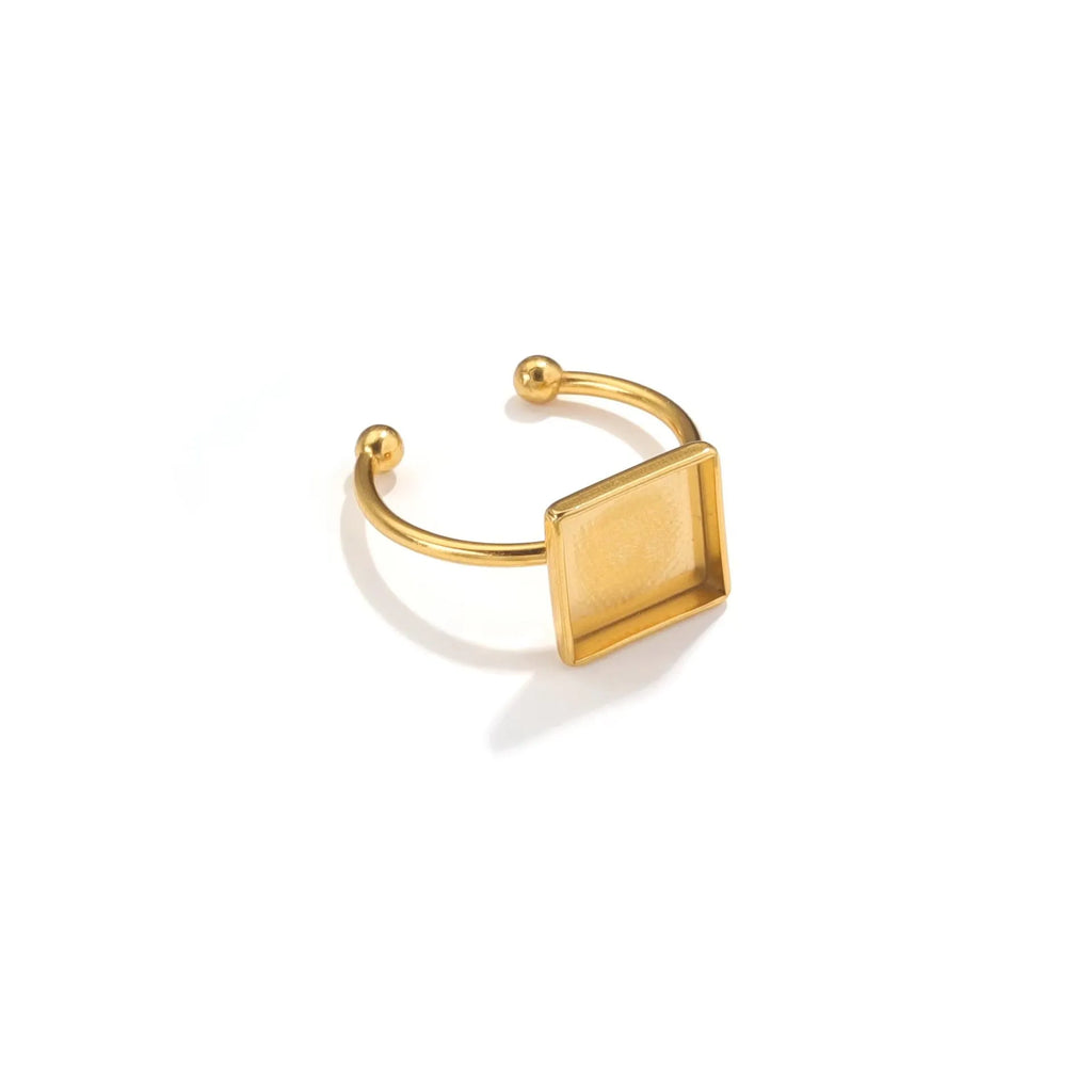 Golden stainless steel ring setting with totem pattern for DIY jewellery making, shown with a ring holder.