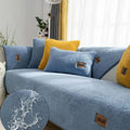 Lambswool solid colour sofa cover in blue on a sofa, showing simple slipcover style.