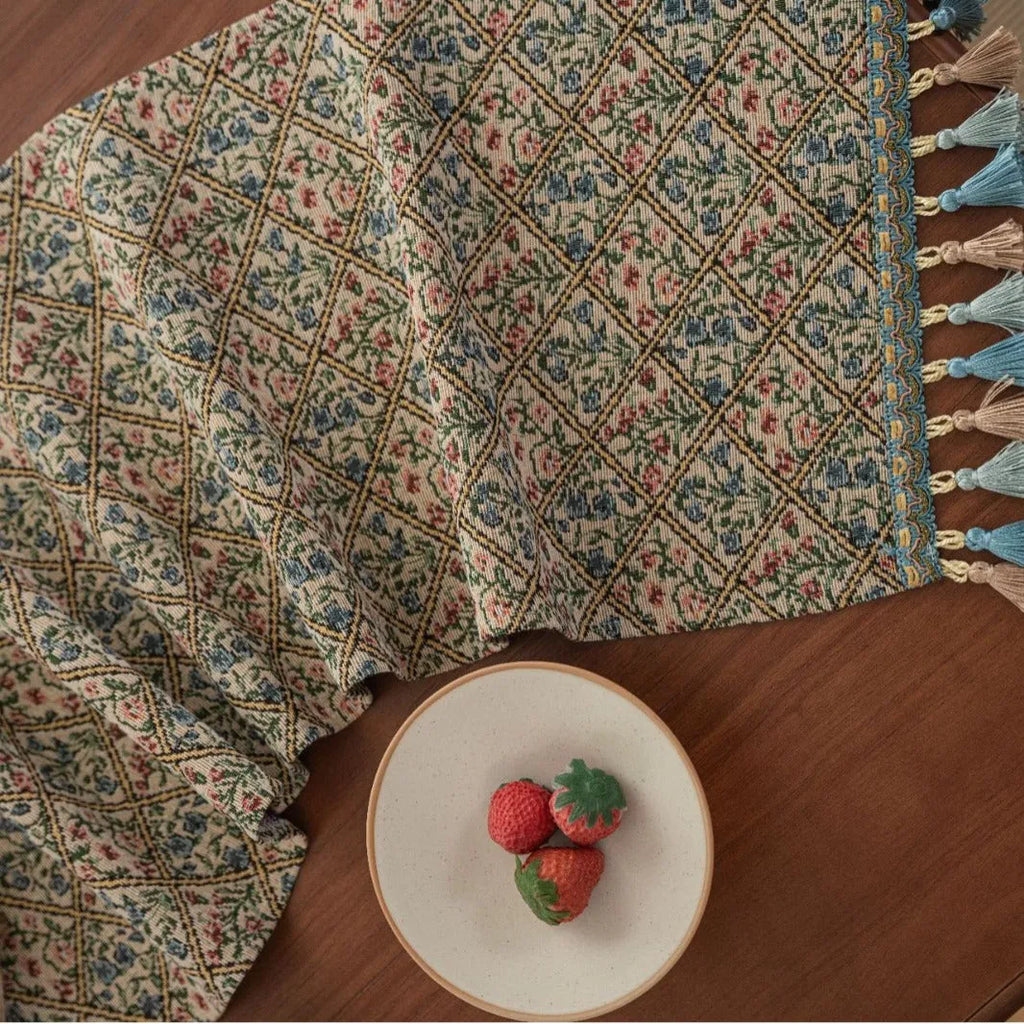 Nordic jacquard bouquet pattern table runner with tassels in dark blue on wooden table