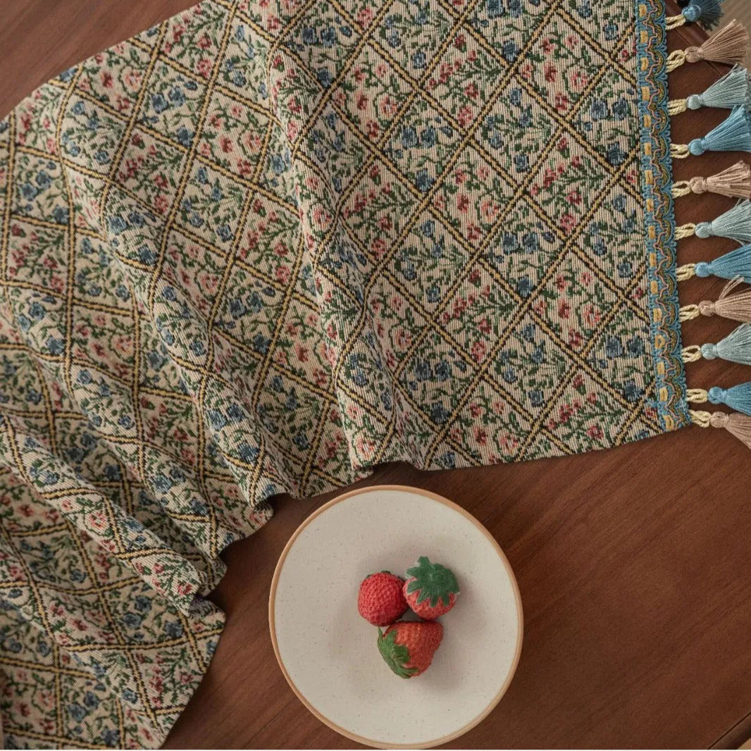 Nordic jacquard bouquet pattern table runner with tassels in dark blue on wooden table