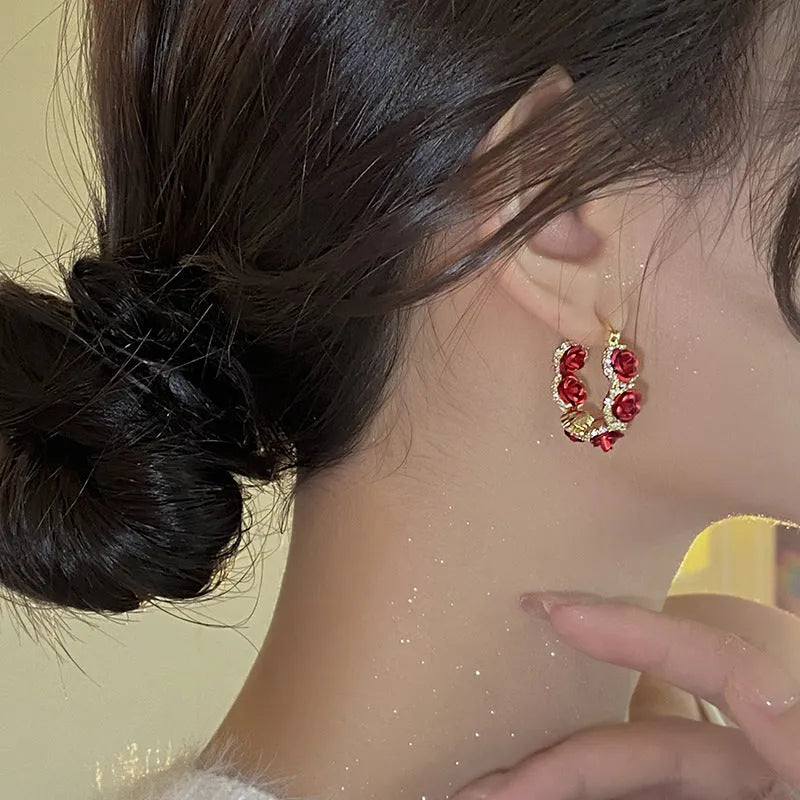 Red alloy clip-on earrings with flower shape and rose-inspired design for women