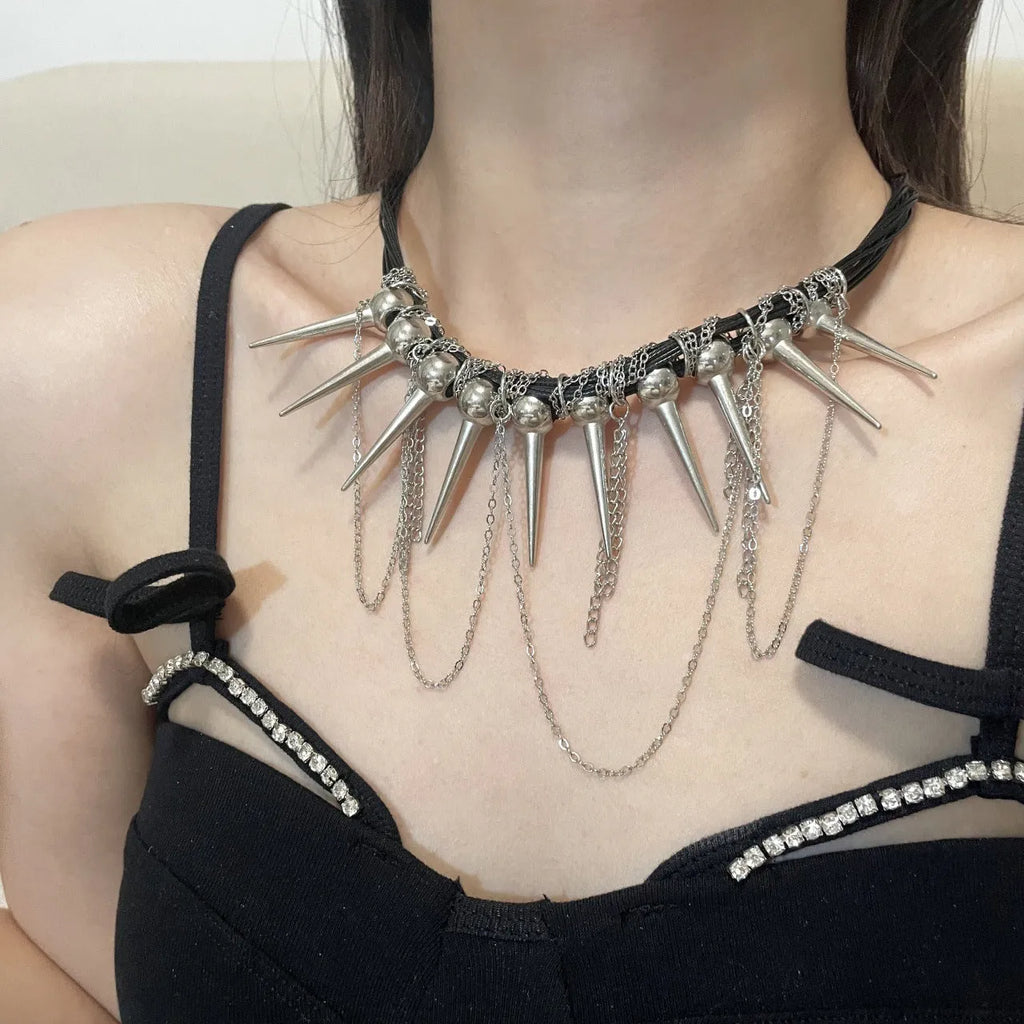 Leather necklace with winding tassel, round beads, and silver point rivet details.