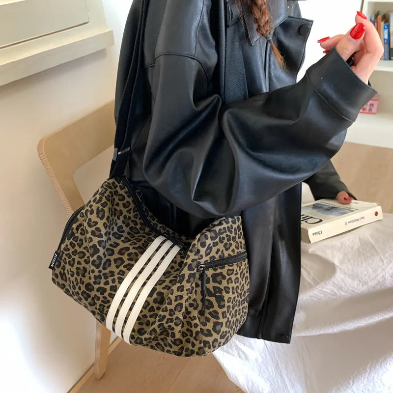 Large capacity sports style messenger bag in leopard print or striped pattern with cross-body strap
