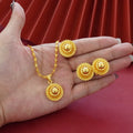 Three-piece gold-plated jewellery set with floral design including pendant necklace, earrings and ring