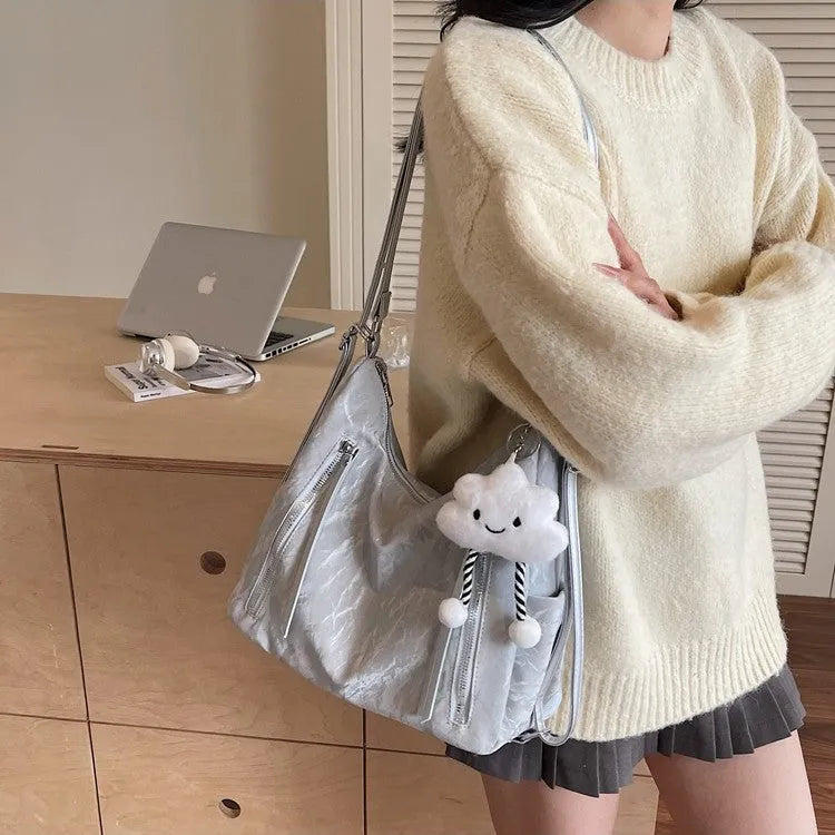 Soft PU women's fashion backpack in beige, shown with attached pendant accessory.