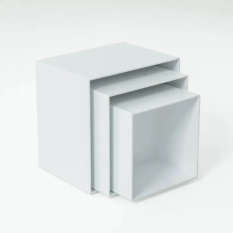 White plastic suit cube stacking dessert display stand with six pieces arranged for cake presentation.