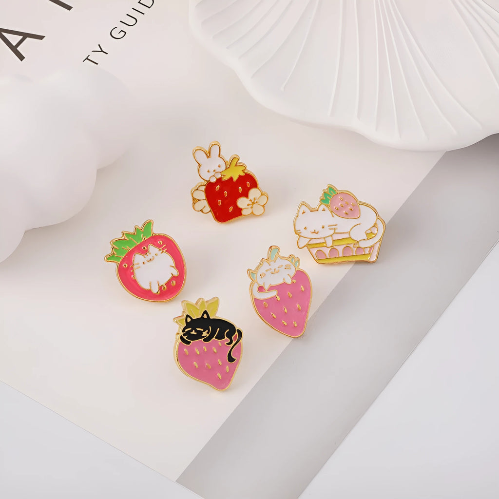 Cat strawberry metal brooch with alloy finish in five colour options on a bag