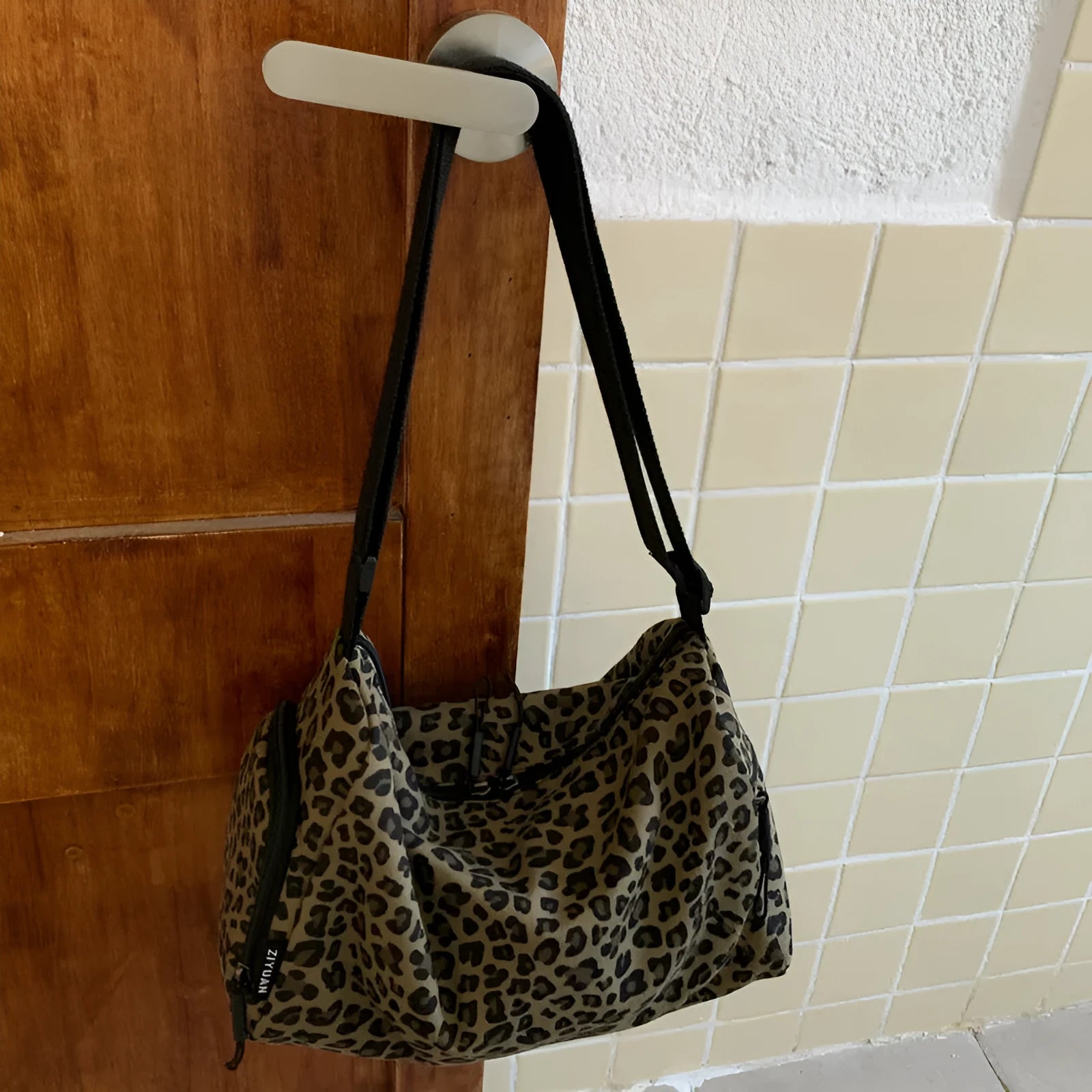 Large capacity sports style messenger bag in leopard print or striped pattern with cross-body strap