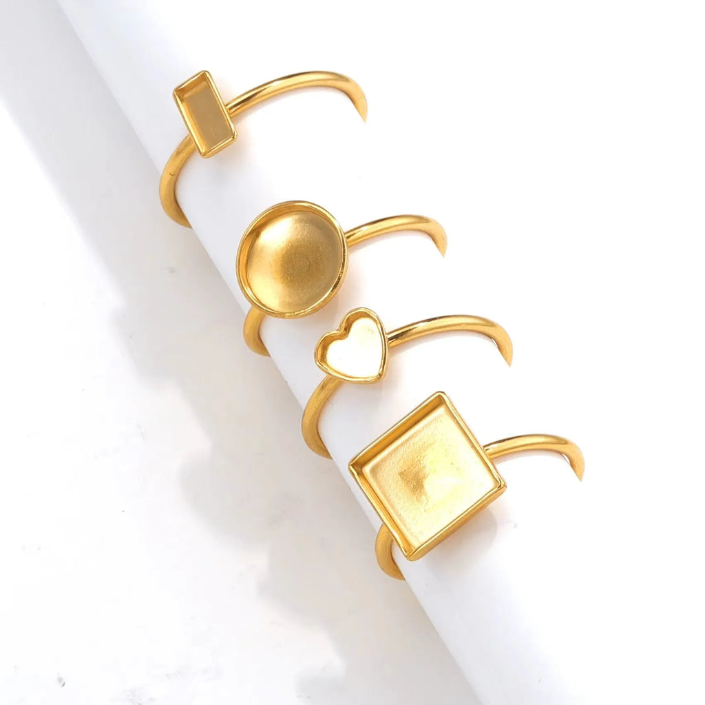 Golden stainless steel ring setting with totem pattern for DIY jewellery making, shown with a ring holder.