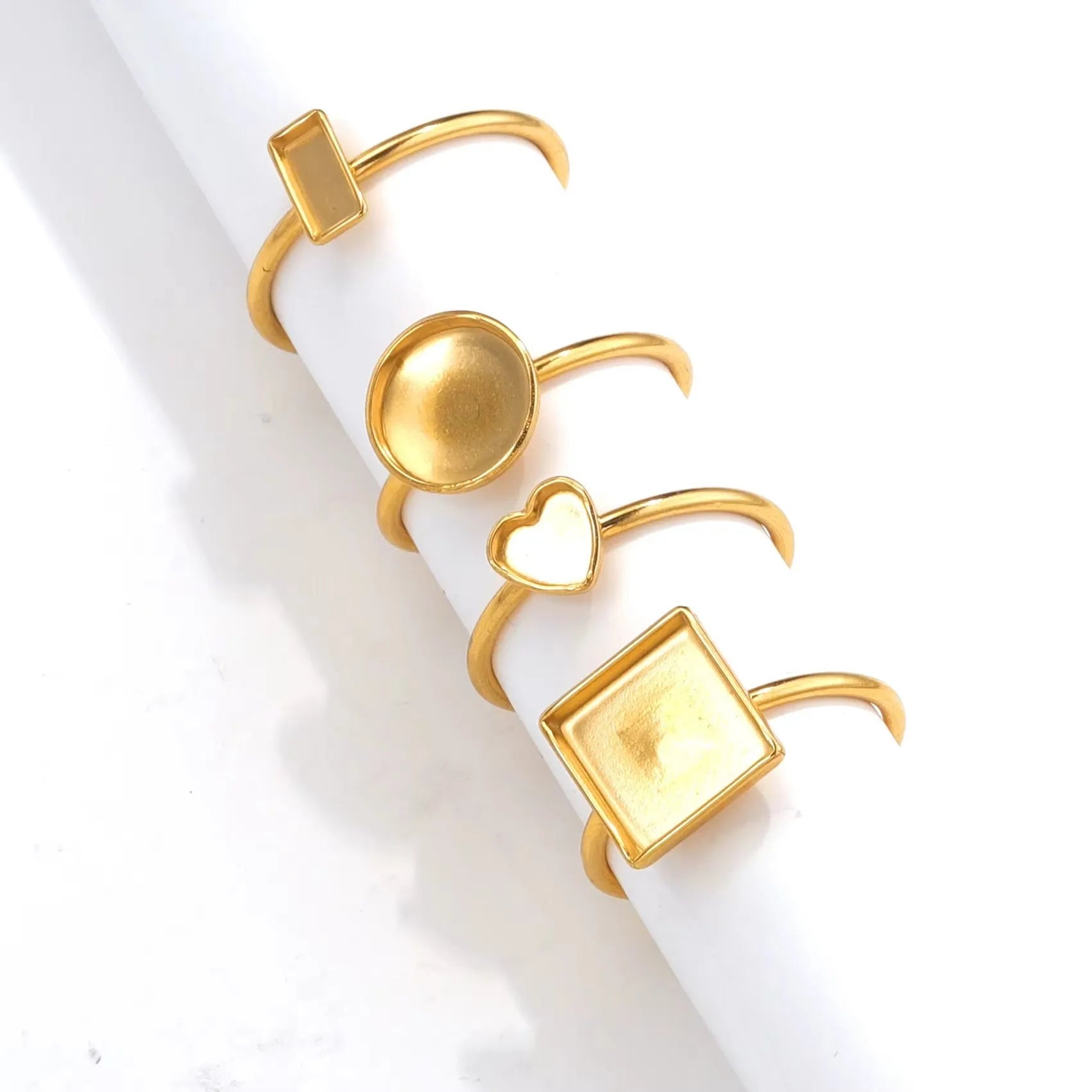 Golden stainless steel ring setting with totem pattern for DIY jewellery making, shown with a ring holder.