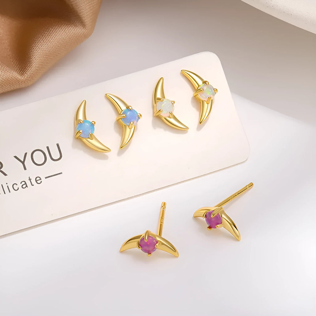 Close-up of women's geometric earrings in 925 silver with electroplated finish and a blue crystal stone.