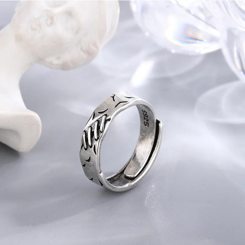 Black geometric adjustable ring with copper construction and round oval elements