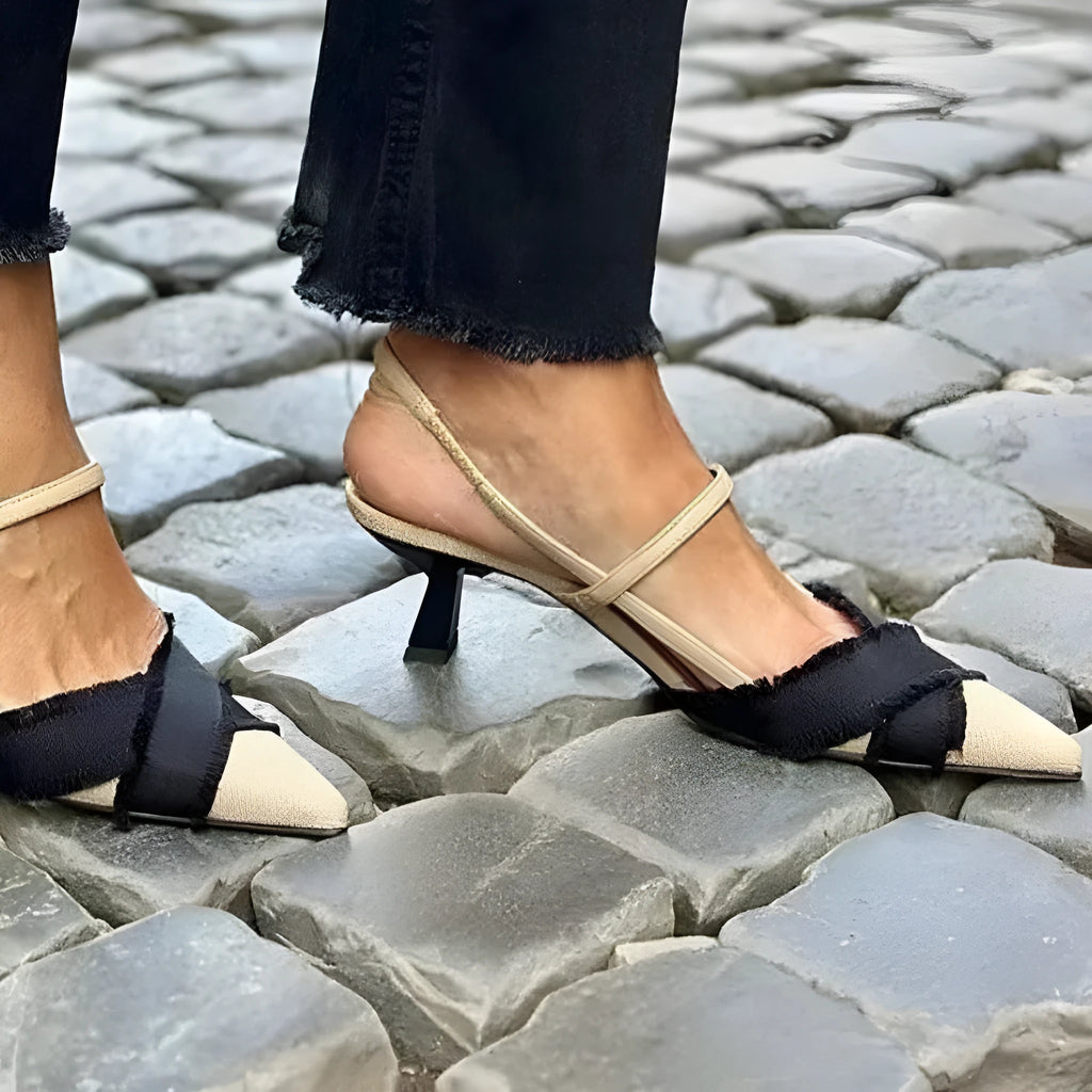 Women's apricot and black colour block pointed toe sandals with a stiletto heel and buckle strap.