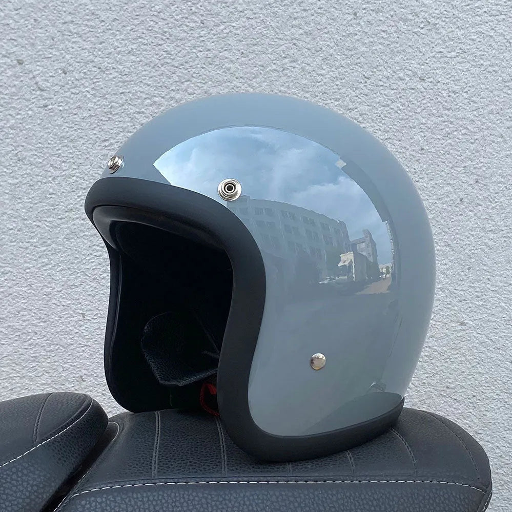 Glass fibre motorcycle half helmet in retro style shown in cement grey colour