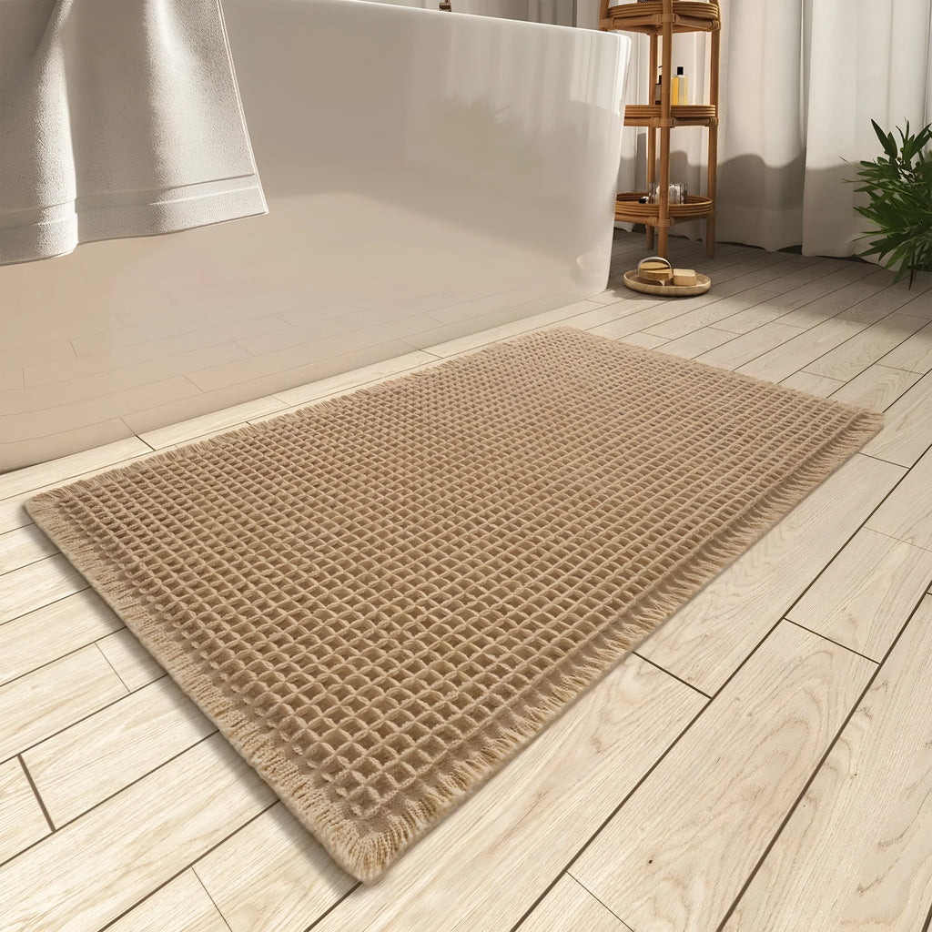 Square checkered pattern bathroom mat on tiled floor in a neutral beige colour.