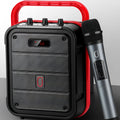 MS62AI portable Bluetooth speaker with wireless microphone on a table, showing remote control and charging cable.