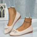 Women's beige casual flat loafers with a bowknot on the front, showing the shallow mouth and rubber sole.