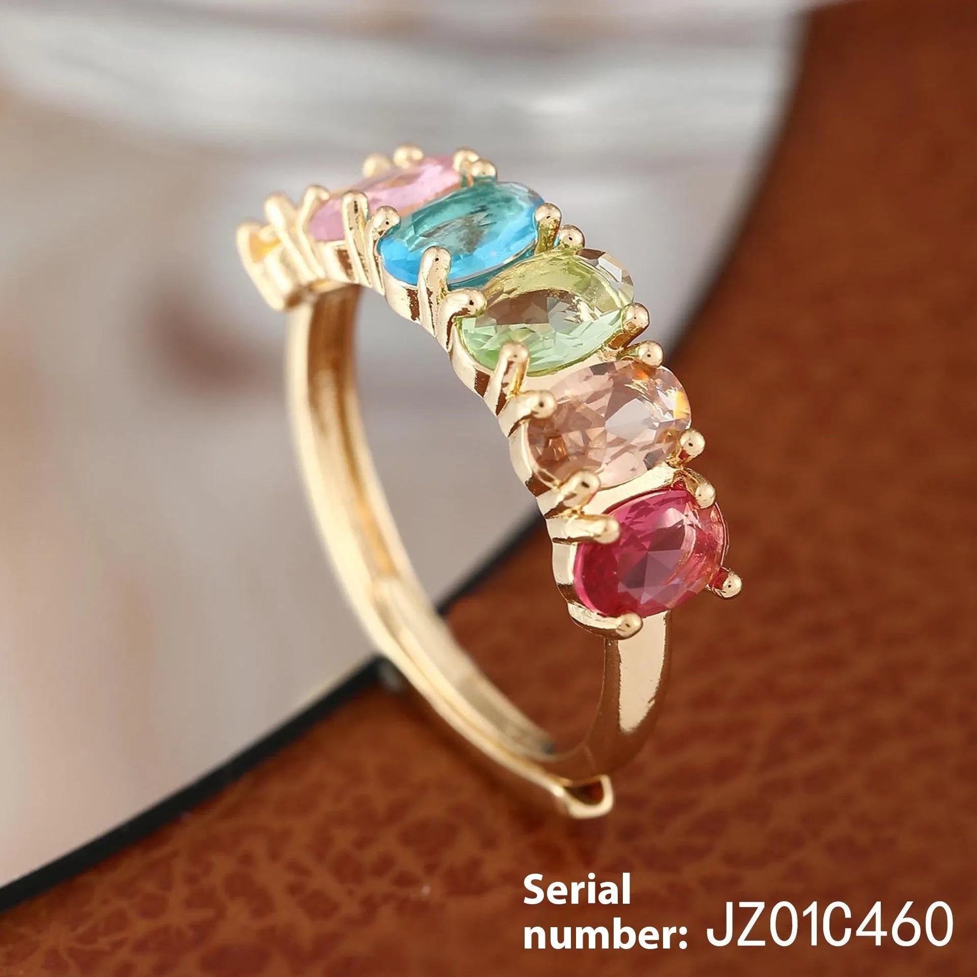 Gold-colour adjustable zircon ring with a simple retro design on a white background.
