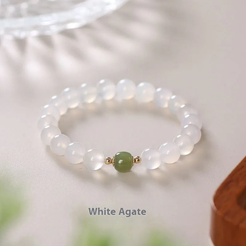 Handmade white agate crystal bracelet with cinnabar accents showing 6mm and 8mm bead sizes