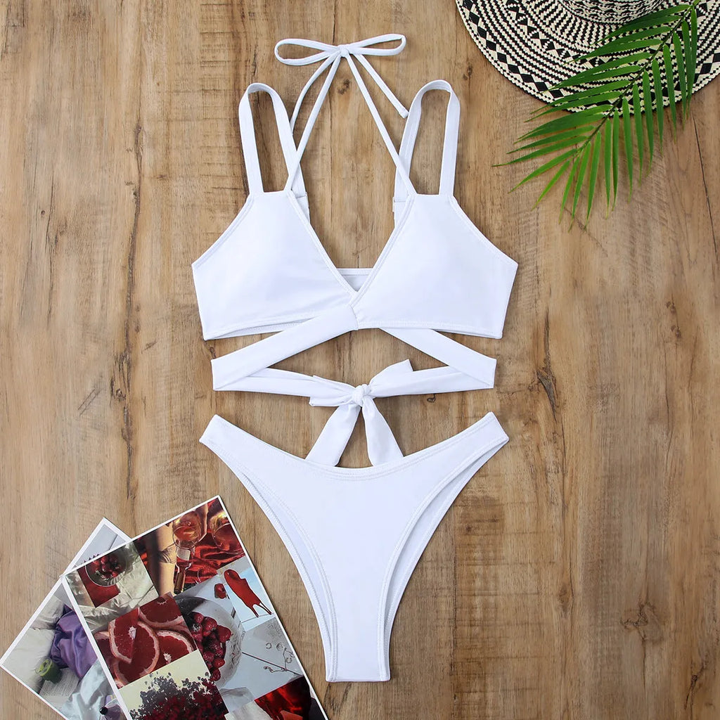 Solid colour strappy women's bikini swimsuit with adjustable side ties and removable padded cups.
